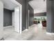Hallway with grey walls and white tiled floor that leads to the kitchen and living room at 2948 Bella Flore Ter, New Smyrna Beach, FL 32168