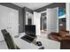 Contemporary home office features gray walls, light flooring and a view through double doors at 2948 Bella Flore Ter, New Smyrna Beach, FL 32168