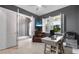 Bright home office with a ceiling fan, neutral colors, white wood-look flooring, and natural light at 2948 Bella Flore Ter, New Smyrna Beach, FL 32168