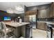 Stylish kitchen with dark cabinets, stainless steel appliances, granite countertops, and modern lighting at 2948 Bella Flore Ter, New Smyrna Beach, FL 32168