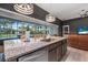 Gourmet kitchen with granite countertops, a large island, stainless steel appliances, and a view of the backyard at 2948 Bella Flore Ter, New Smyrna Beach, FL 32168