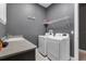 Well-lit laundry room featuring a modern washer and dryer, ample counter space, and convenient shelving for storage at 2948 Bella Flore Ter, New Smyrna Beach, FL 32168