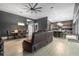 Open-concept living room with a view into the kitchen, hardwood floors, and comfortable furnishings at 2948 Bella Flore Ter, New Smyrna Beach, FL 32168