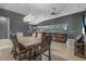 Open-concept living space features hardwood floors, dark walls, and a view of the backyard pool at 2948 Bella Flore Ter, New Smyrna Beach, FL 32168