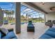Screened lanai showcases a refreshing pool, lounge chairs, and outdoor seating with views of the landscape at 2948 Bella Flore Ter, New Smyrna Beach, FL 32168