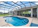 Captivating screened-in pool area featuring clear blue water, seating area, and inviting outdoor space at 2948 Bella Flore Ter, New Smyrna Beach, FL 32168