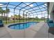 Inviting screen-enclosed pool area with a peaceful, relaxed atmosphere and lush landscaping at 2948 Bella Flore Ter, New Smyrna Beach, FL 32168