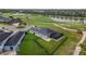 Aerial shot showcasing a home with a screened pool and fenced backyard, nestled in a golf community at 2948 Bella Flore Ter, New Smyrna Beach, FL 32168