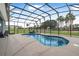 Inviting screened-in pool with a tranquil setting and well-maintained surrounding landscape at 2948 Bella Flore Ter, New Smyrna Beach, FL 32168