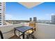 Balcony seating with outdoor table and chairs with city views, perfect for enjoying the outdoors at 2987 S Atlantic Ave # 901, Daytona Beach, FL 32118