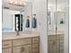 Bathroom with a vanity, large mirror and cabinets, next to the bedroom at 2987 S Atlantic Ave # 901, Daytona Beach, FL 32118