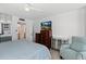 Bedroom featuring a TV, dressers, mirrored closet doors, and comfortable seating at 2987 S Atlantic Ave # 901, Daytona Beach, FL 32118