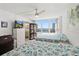 Bright bedroom featuring two beds with seashell-patterned bedding and a large window offering a water view at 2987 S Atlantic Ave # 901, Daytona Beach, FL 32118