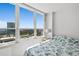 Bedroom featuring a large window with city views, adorned with blue seashell bedding at 2987 S Atlantic Ave # 901, Daytona Beach, FL 32118