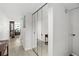 Bright hallway featuring mirrored closet doors and wood-look floors leading into the living area at 2987 S Atlantic Ave # 901, Daytona Beach, FL 32118