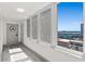 Bright condo hallway with natural light, gray wood floors, and views of the water at 2987 S Atlantic Ave # 901, Daytona Beach, FL 32118
