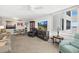 Cozy living room with furniture, TV, and side table next to a window and chair at 2987 S Atlantic Ave # 901, Daytona Beach, FL 32118