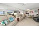 Comfortable living room with mirrored wall, sofas, chandelier, and dining area at 2987 S Atlantic Ave # 901, Daytona Beach, FL 32118