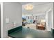View of the living room with neutral colors, TV, furniture, ceiling fan, and large sliding doors to the balcony at 2987 S Atlantic Ave # 901, Daytona Beach, FL 32118