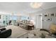 Open living space with sofas, dining area, chandelier, and balcony access with views at 2987 S Atlantic Ave # 901, Daytona Beach, FL 32118