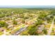 High-angle aerial shot showing the property in a serene, tree-lined residential area at 3035 Victory Palms Dr, Edgewater, FL 32141