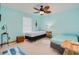Comfortable bedroom with ceiling fan, two twin beds and beachy decor at 3035 Victory Palms Dr, Edgewater, FL 32141
