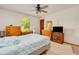 Inviting bedroom with a large window, ceiling fan, wooden dresser and TV at 3035 Victory Palms Dr, Edgewater, FL 32141