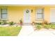 Charming home entrance featuring a decorative wreath and well-maintained landscaping at 3035 Victory Palms Dr, Edgewater, FL 32141