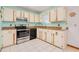 Classic kitchen with ample cabinet space and modern appliances, including a stainless steel oven at 3035 Victory Palms Dr, Edgewater, FL 32141