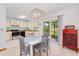 Eat-in kitchen with tiled floor, modern light fixture and stainless appliances. Sliding doors to patio at 3035 Victory Palms Dr, Edgewater, FL 32141