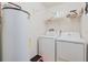 Practical laundry area with washer, dryer and hot water heater at 3035 Victory Palms Dr, Edgewater, FL 32141