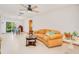 Bright living room featuring a ceiling fan, tile floors, and sliding glass doors to the backyard at 3035 Victory Palms Dr, Edgewater, FL 32141