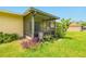Relaxing screened porch offers comfortable seating and a view of the backyard at 3035 Victory Palms Dr, Edgewater, FL 32141