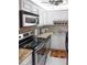 Well-lit kitchen showcases stainless steel appliances, white cabinetry, and granite countertops at 3043 S Atlantic Ave # 204, Daytona Beach, FL 32118
