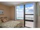 Bedroom boasts natural light and stunning ocean views, with a glimpse of the community pool at 3043 S Atlantic Ave # 204, Daytona Beach, FL 32118