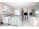 Bright bedroom features a neutral palette, soft bedding, a large dresser and mirror at 3043 S Atlantic Ave # 204, Daytona Beach, FL 32118