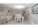Dining area features a white table and chairs, offering a cozy spot for meals at 3043 S Atlantic Ave # 204, Daytona Beach, FL 32118