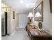Hallway with decorative table and stainless steel appliances at 3043 S Atlantic Ave # 204, Daytona Beach, FL 32118