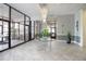 Bright lobby area featuring modern tile flooring, chandelier, and plants at 3043 S Atlantic Ave # 204, Daytona Beach, FL 32118