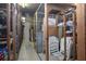 View of the storage unit with wire mesh doors, overhead lighting, and ample room for storage at 3043 S Atlantic Ave # 204, Daytona Beach, FL 32118