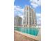 View of the outdoor swimming pool and sundeck for residents with views of the high rise condo building at 3043 S Atlantic Ave # 204, Daytona Beach, FL 32118