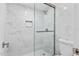 Updated shower with glass door, marble tiling, and modern fixtures in bathroom at 3047 S Atlantic Ave # 1805, Daytona Beach, FL 32118