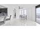 Dining area with modern table and ceiling fan, featuring large windows with ocean views at 3047 S Atlantic Ave # 1805, Daytona Beach, FL 32118