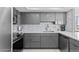 Modern kitchen featuring sleek gray cabinets, stainless steel appliances, and a stylish backsplash at 3047 S Atlantic Ave # 1805, Daytona Beach, FL 32118