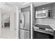 A view of the kitchen appliances with marble floors that extends into the bathroom at 3047 S Atlantic Ave # 1805, Daytona Beach, FL 32118