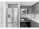 Bright kitchen featuring stainless steel appliances and gray cabinets at 3047 S Atlantic Ave # 1805, Daytona Beach, FL 32118