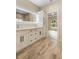 Modern bathroom with double vanity, storage, and tile floors at 349 Baker Ave, Lake Helen, FL 32744