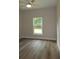 Bright bedroom with natural light, wood look flooring and a ceiling fan at 349 Baker Ave, Lake Helen, FL 32744