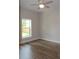 Well-lit bedroom featuring hard wood floors and a window view at 349 Baker Ave, Lake Helen, FL 32744