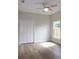 Bright bedroom with wood floors, closet, and natural light at 349 Baker Ave, Lake Helen, FL 32744